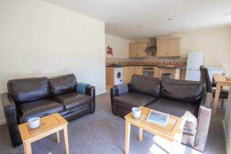 A bright and inviting living room featuring com...