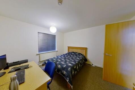 Cozy single bedroom featuring a comfortable sin...
