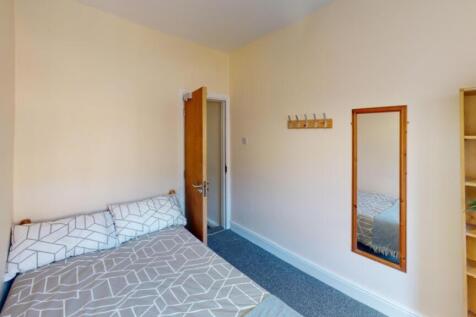 This inviting double bedroom features a cozy la...