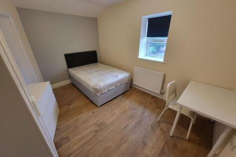 This inviting double bedroom features a comfort...