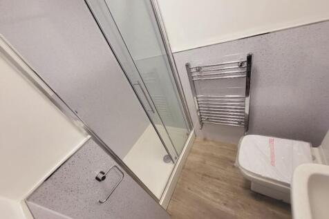 This modern bathroom features a sleek shower en...