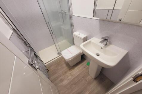 A modern bathroom featuring a sleek shower, con...