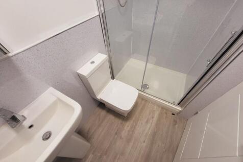 A modern bathroom featuring a sleek shower and ...