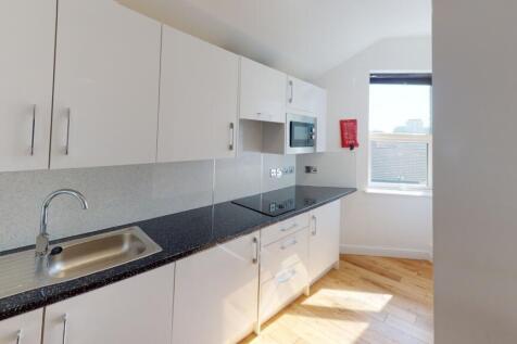 Bright and modern kitchen featuring sleek white...