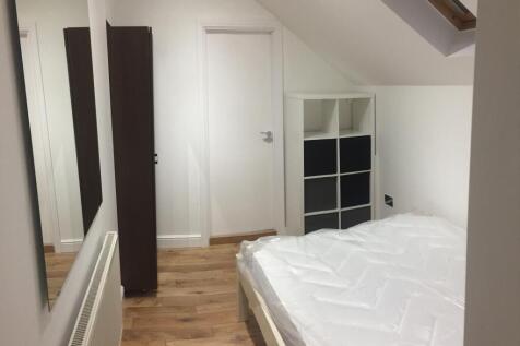 A neat and modern double bedroom featuring a fr...