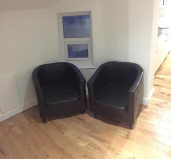 A cozy communal lounge corner featuring two com...