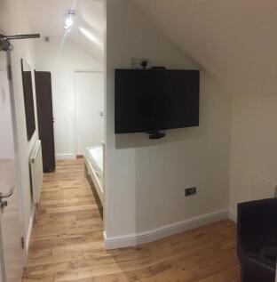 A neat and modern hallway area featuring a wall...