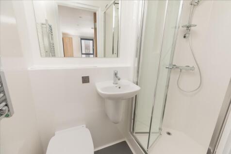 A modern and pristine bathroom featuring a slee...