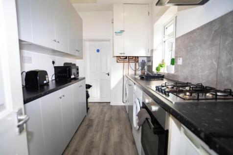 This modern kitchen features sleek cabinetry an...