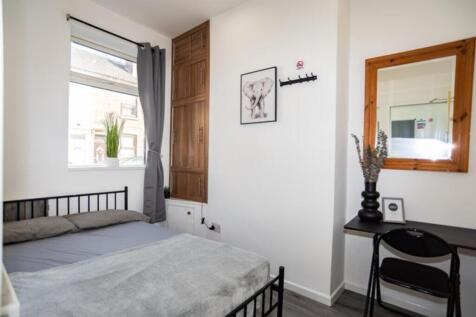 This inviting double bedroom features a comfort...