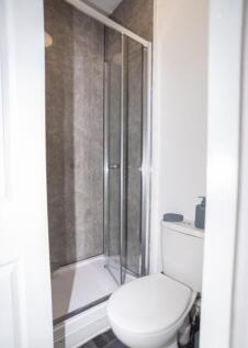 A modern bathroom featuring a sleek shower encl...