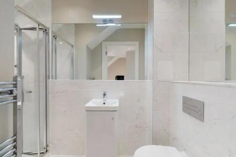 Bright and modern bathroom suite featuring slee...