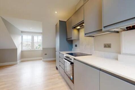 Modern kitchen with sleek grey cabinetry and in...