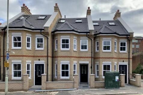 A modern terraced house with a neat brick façad...