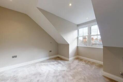 Bright and airy bedroom featuring a large windo...