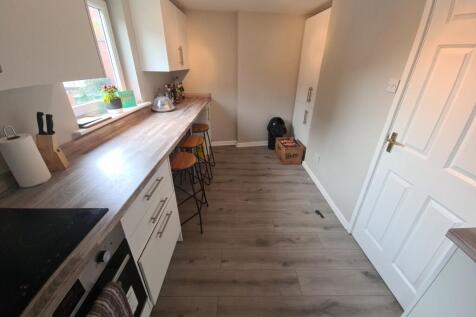 Bright and modern kitchen space featuring ample...
