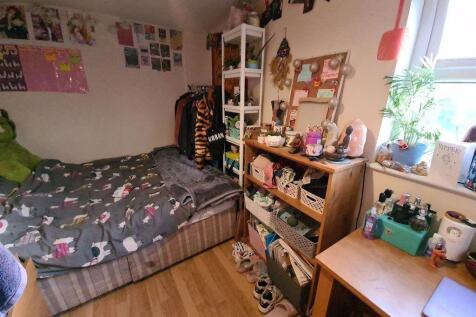 Cozy and well-organized bedroom featuring a com...