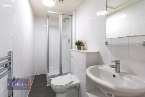 Bright and tidy bathroom featuring modern white...