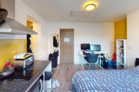 This inviting double bedroom features a cozy at...