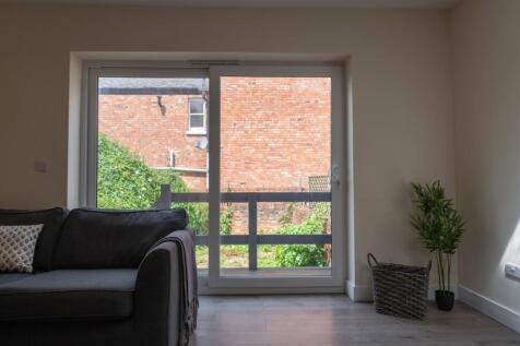 Bright and inviting living room featuring large...