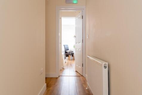 Bright and well-maintained hallway leading to a...