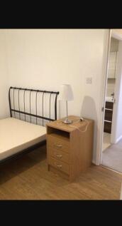 Cozy double bedroom featuring a stylish metal b...