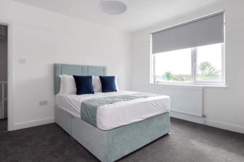 A bright and airy double bedroom featuring a co...