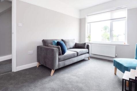 A bright and modern living room featuring a com...