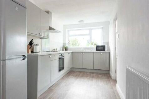 Bright and modern kitchen featuring sleek grey ...