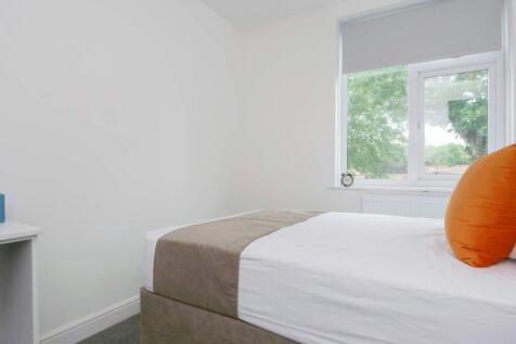 A bright and tidy single bedroom featuring a la...
