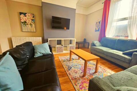 A spacious and welcoming living room featuring ...