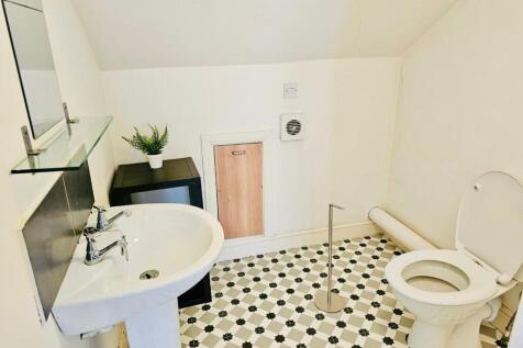 Bright and clean bathroom with a white sink, to...