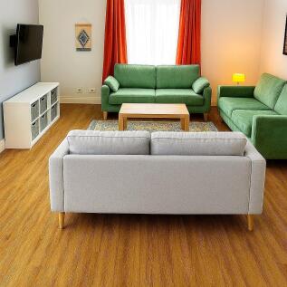 Well-lit and tidy living room featuring comfort...