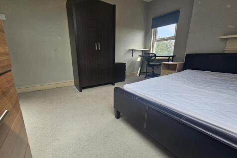 A well-maintained student bedroom featuring a c...