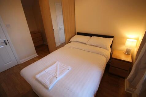 Cozy double bedroom featuring warm, inviting to...
