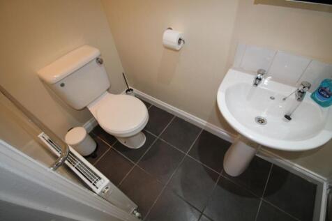 A tidy and well-maintained single toilet featur...