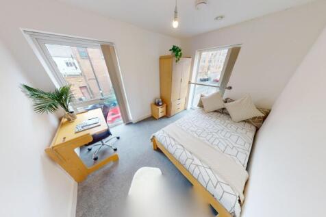 Bright and airy double bedroom featuring a comf...
