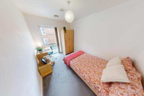 A bright and tidy single bedroom featuring a co...