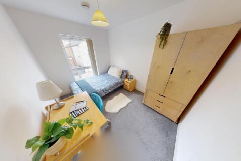 A bright and tidy single bedroom featuring a co...