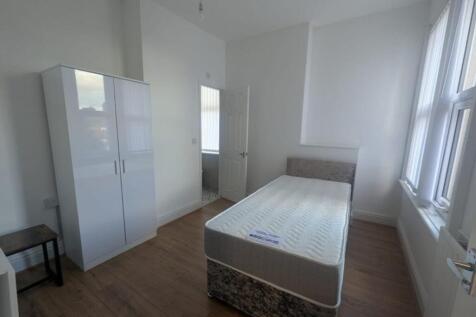 Bright and spacious double bedroom featuring a ...