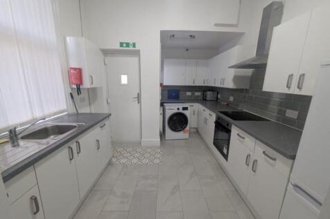 Spacious kitchen equipped with modern appliance...