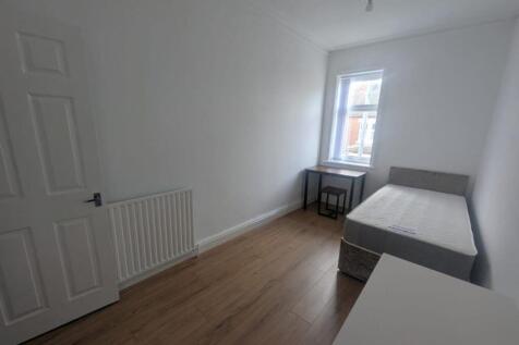 A bright and spacious double bedroom featuring ...