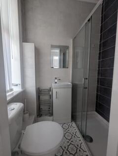 A modern bathroom featuring a sleek shower, sty...