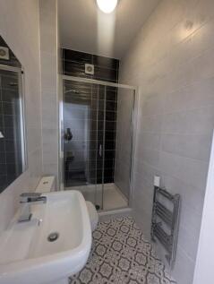 This modern bathroom features a sleek shower en...