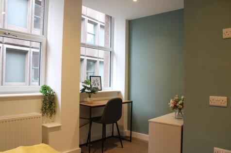 A bright and inviting double bedroom featuring ...