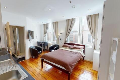 Bright and spacious master bedroom featuring a ...