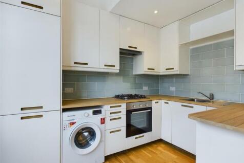 A modern and tidy kitchenette featuring sleek c...