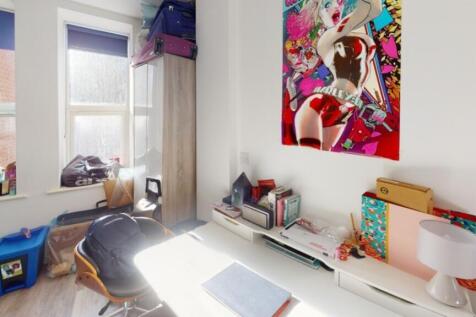 A vibrant double bedroom featuring ample natura...