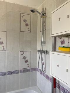A well-maintained bathroom featuring a convenie...