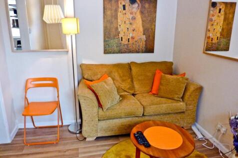 A cozy living room featuring a comfortable sofa...
